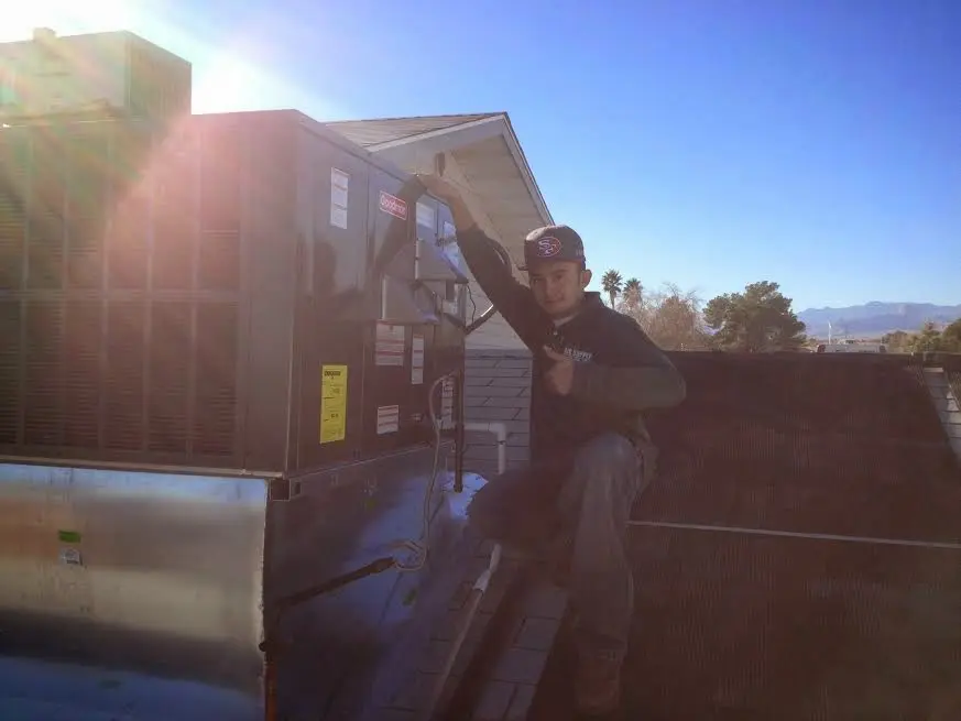 HVAC technician performing HVAC Inspection on a rooftop unit in Niskayuna